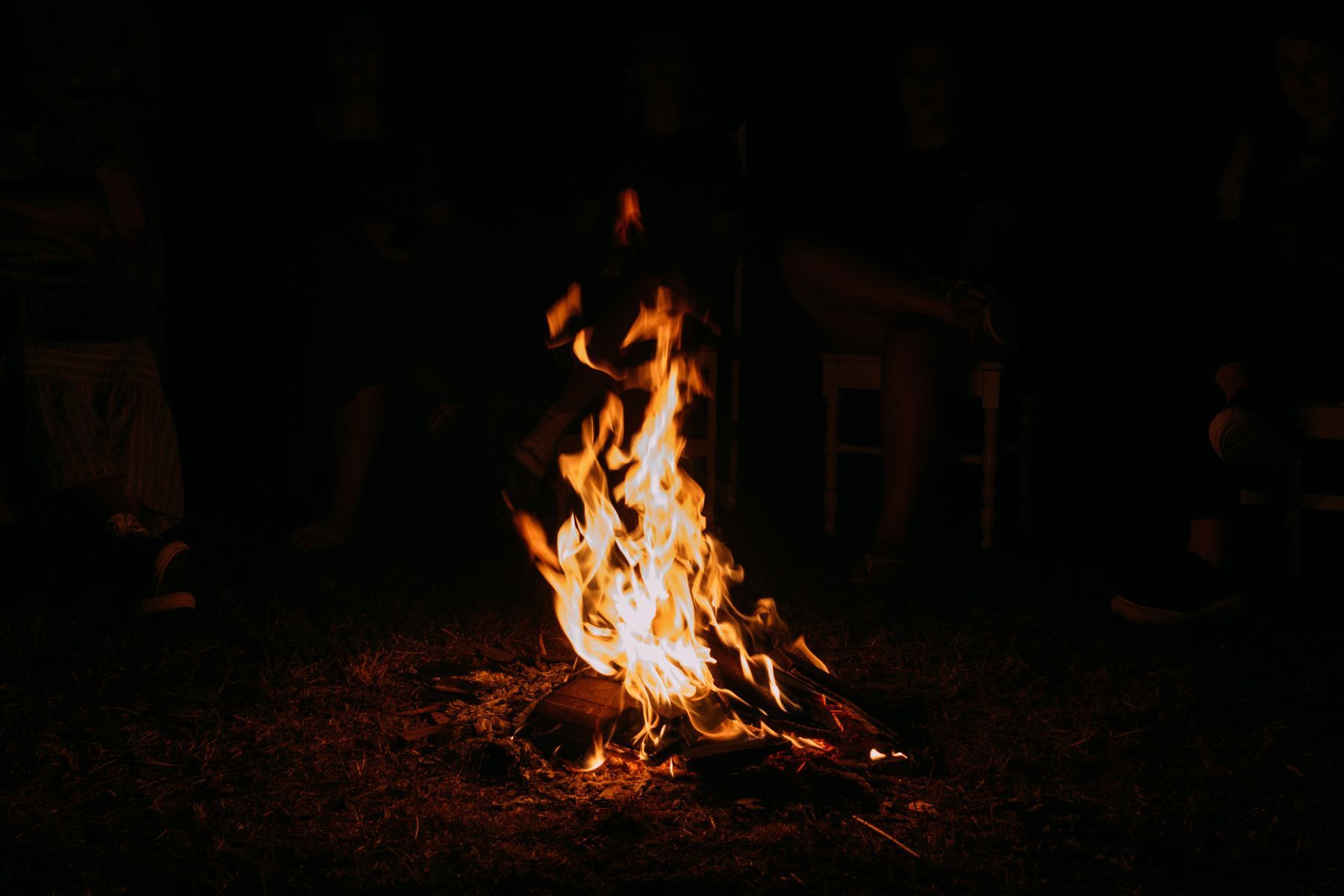 A warm campfire surrounded by friends