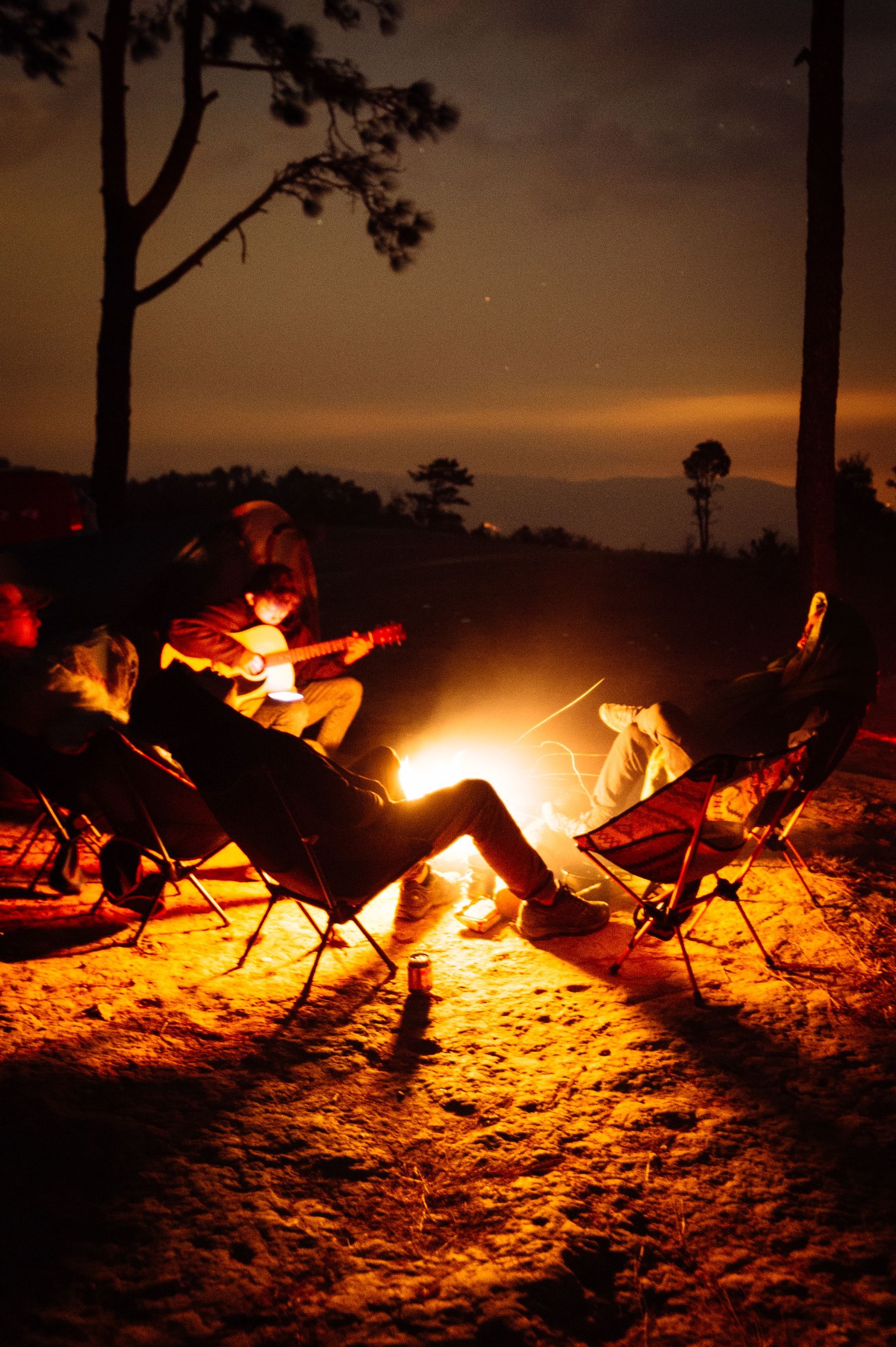 Friends around a campfire at night